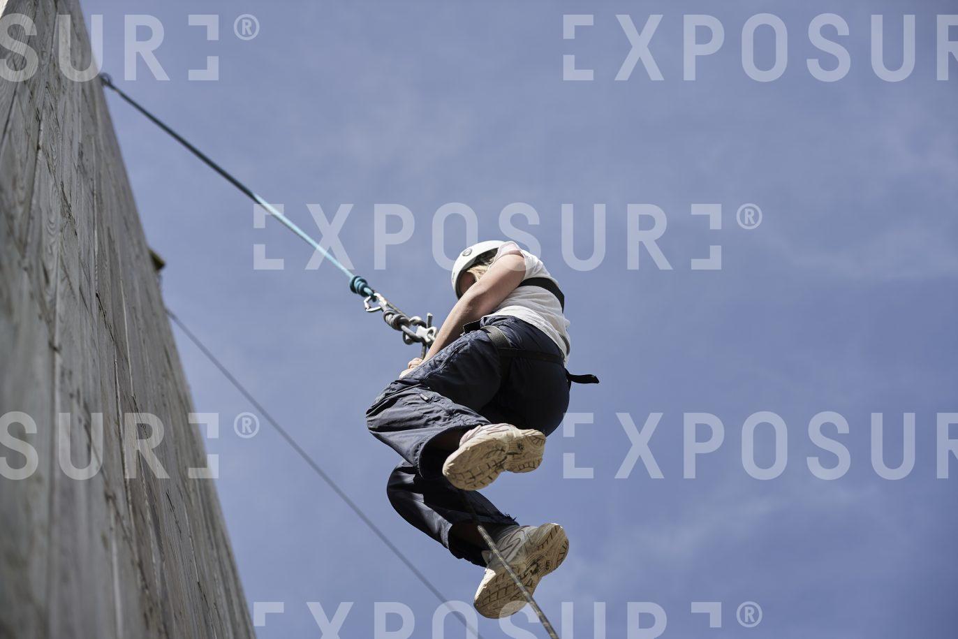 A young girl abseiling