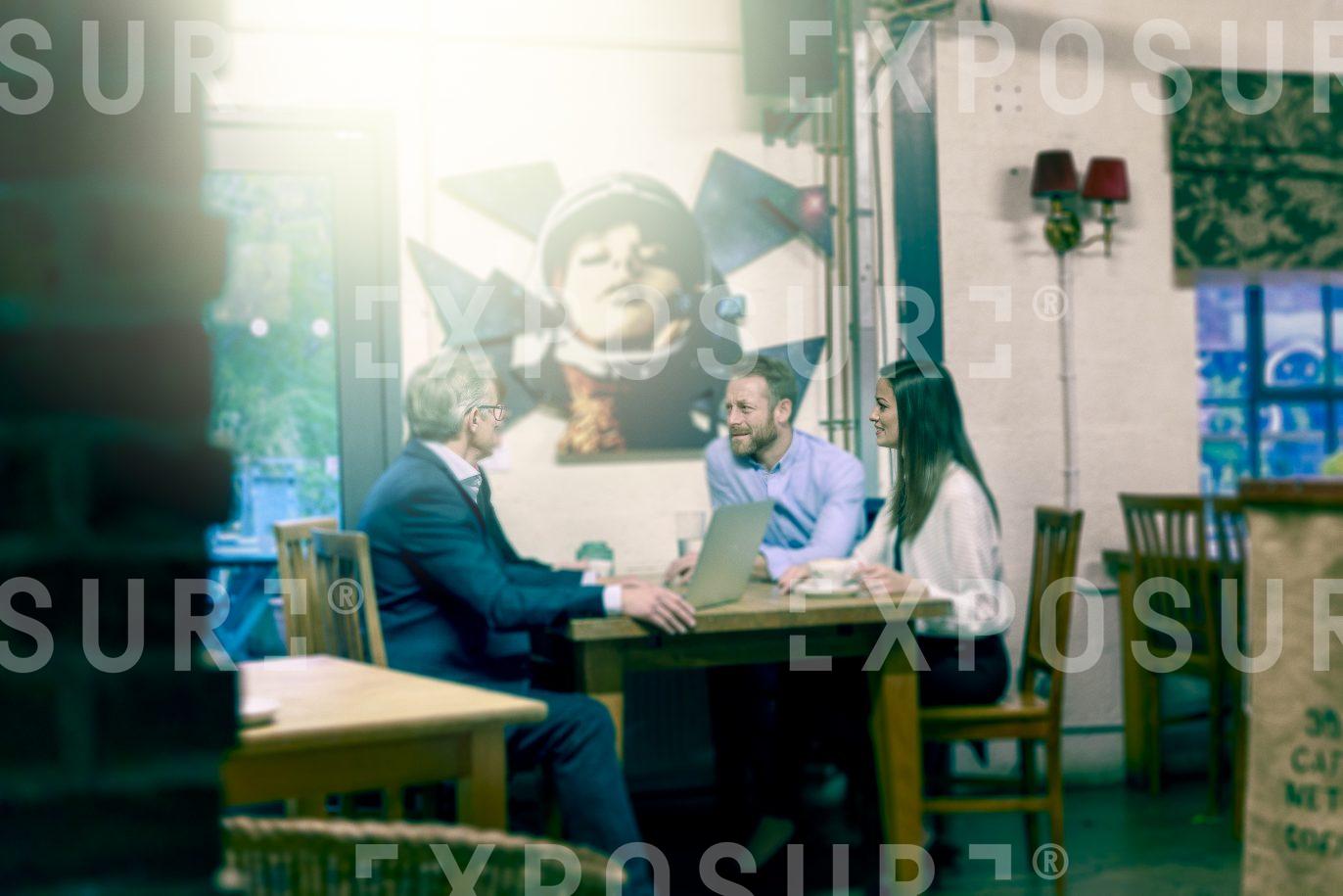 People Having Meeting In Cafe