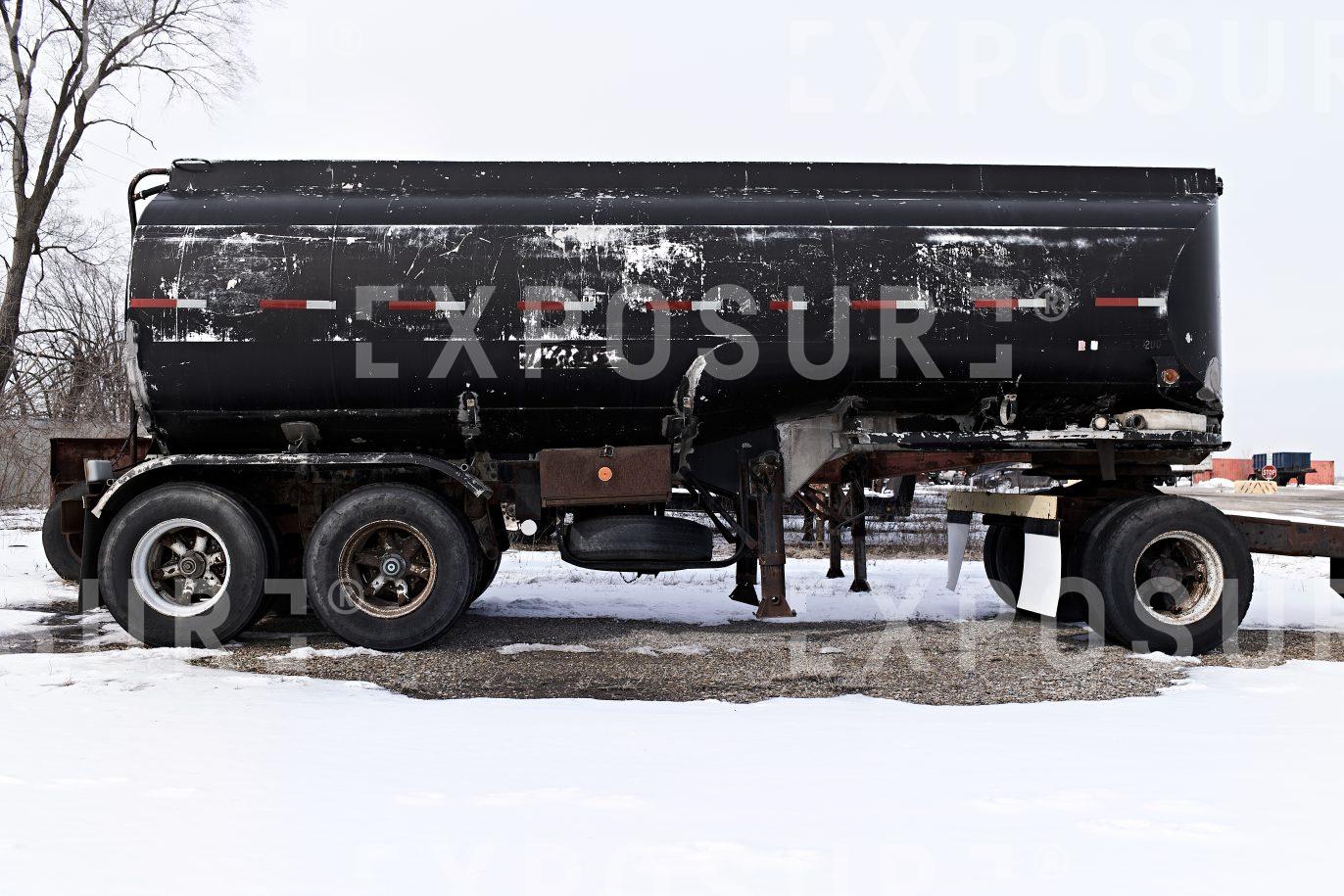 Old black tanker parked, Midwest