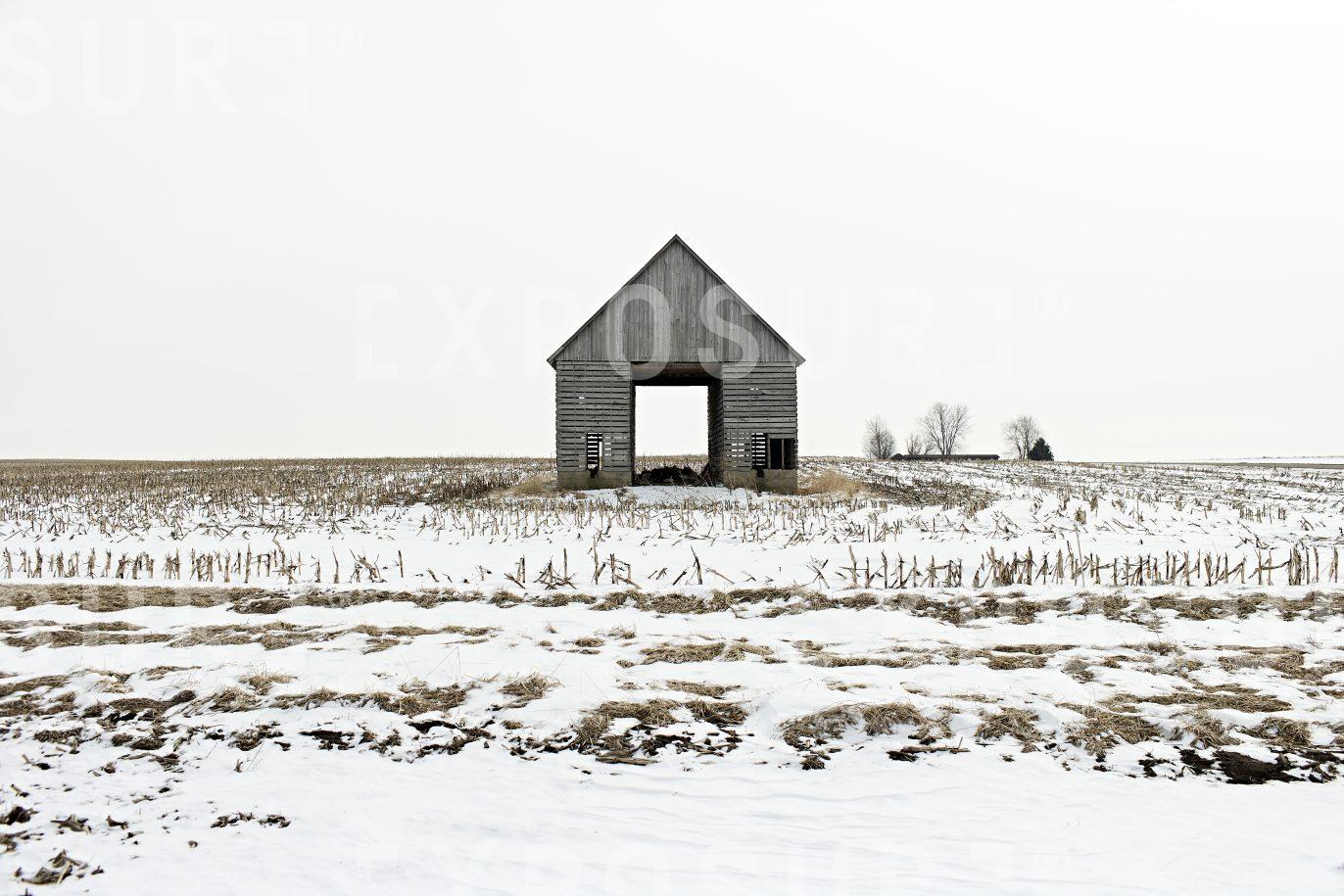 Open barn, snowy field, Midwest